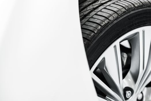 New Car Tire Closeup Photo. Modern Car Alloy Wheel.