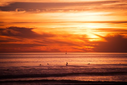 Surfers and the Ocean. Southern California Ocean Sunset with Surfers Awaiting Big Wave.