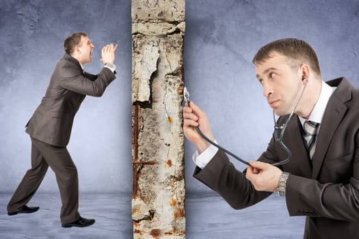 Businessman with stethoscope hearing grey wall with man