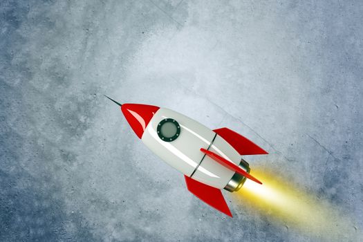 Space rocket with fire on grey wall background