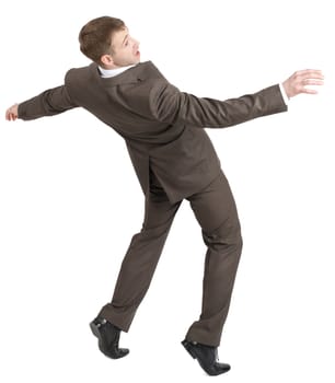Businessman almost falling back with arms up isolated on white background