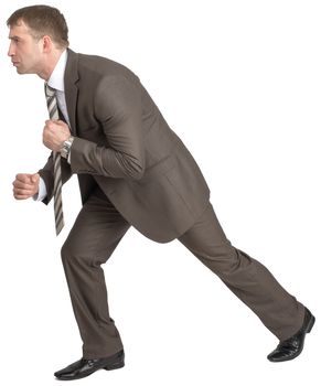 Businessman pulling invisible rope isolated on white background, side view