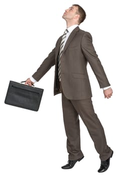 Businessman with black briefcase looking up isolated on white background