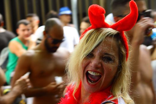 BRAZIL, Rio de Janeiro: A woman is dressed up as a devil as thousands of revelers take over the city on January 23, 2016 in a massive street party two weeks ahead of Carnival.  In the weeks leading up to the Carnival's official opening day on February 5, 2016, groups of people organize 'blocos', or street parties. Blocos are usually held in local neighbourhoods and feature brass bands and are much less formal than the parades.	 