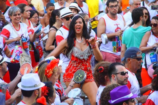 BRAZIL, Rio de Janeiro: A woman danses as thousands of revelers take over the city on January 23, 2016 in a massive street party two weeks ahead of Carnival.  In the weeks leading up to the Carnival's official opening day on February 5, 2016, groups of people organize 'blocos', or street parties. Blocos are usually held in local neighbourhoods and feature brass bands and are much less formal than the parades.	 
