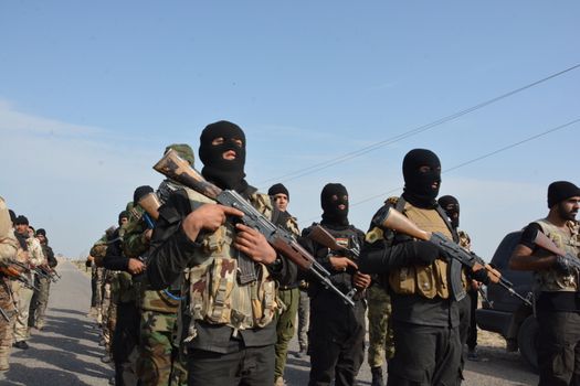 IRAQ, Al-Seneia: Soldiers gather in the town of Al-Seneia, on January 23, 2016, after the PMU liberated the city from ISIS.The city was liberated on October 14, 2015, according to commander of Imam Ali brigade who spoke with our contributor. ISIS is said to have destroyed much of the town including important building such as schools and hospitals.