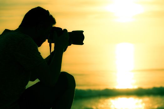 Professional Photographer on Location Closeup. Sunset Photography.