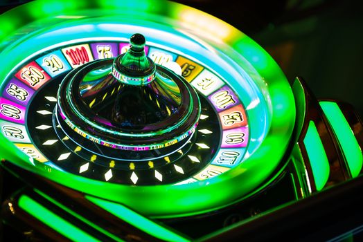 Colorful Neon Illuminated Roulette Casino Game Closeup. Las Vegas Casino Games.
