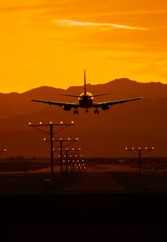 Airplane Travel at Sunset. Airliner Landing in Las Vegas Nevada During Scenic Sunset.