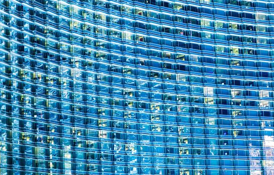 Blue Glassy Building Background. Hundreds of Windows Architecture Backdrop. Modern Architecture.