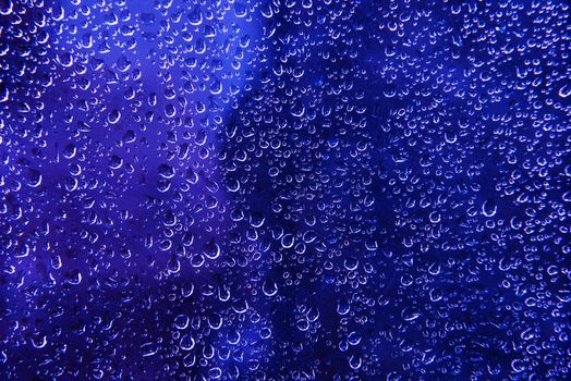 Blue Water Beads Background. Blue Wet Glass Photo Backdrop.