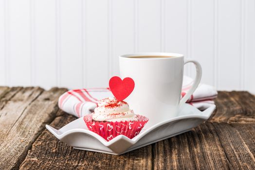 Valentines inspired red velvet cupcake served with coffee.