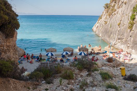 Zakynthos, Greece - August 27, 2015: Tourists on the Xigia beach with a sulfur and collagen spring on Zakynthos, Greece