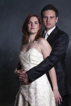 Portrait Of Young Married Couple Over Black Background