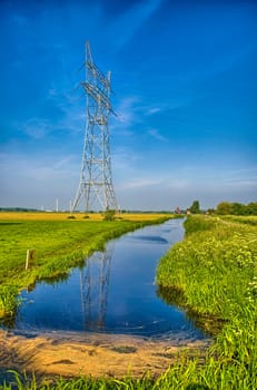 Dutch landscape with a canal and grass fields with mirror reflection in water, Amsterdam, Holland, Netherlands, HDR