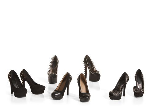 Collection of black high heel shoes on white background
