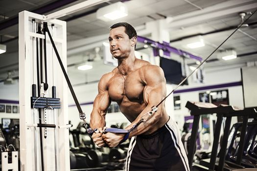 Muscular man exercising in gym