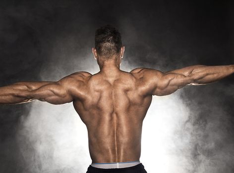 Back of strong muscular with hand extended