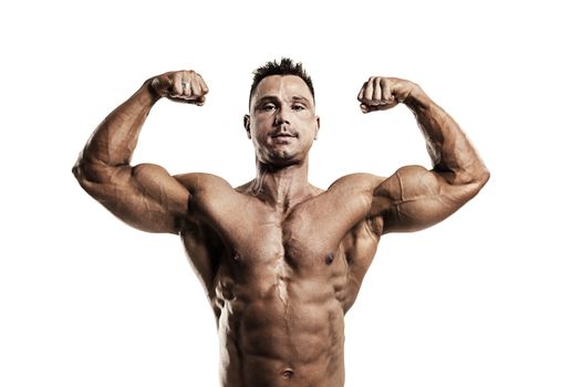 Strong muscular man showing biceps on white background