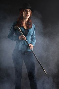 Portrait Of Female Magician Over Black Background