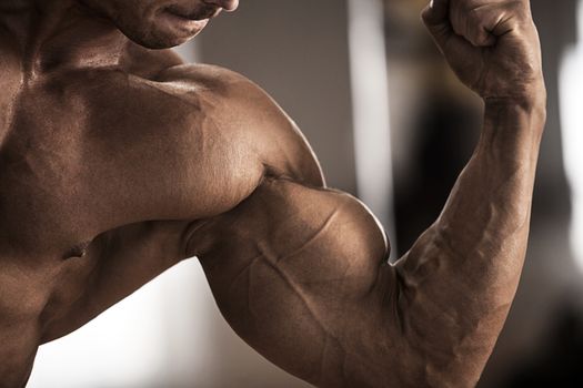 Male bodybuilder flexing his muscles