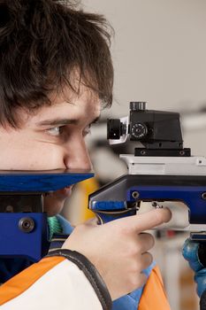 Man training sport shooting with air rifle gun