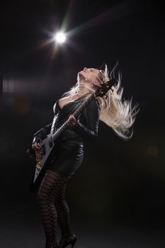 Young Blonde Woman Playing Guitar; Indoor