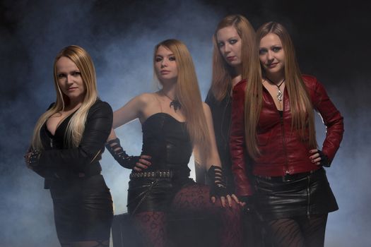 Group Of Female Friends Standing In Smoke; Indoors