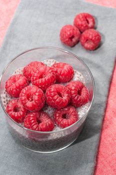 Pudding raspberries and chia seeds on a tablecloth