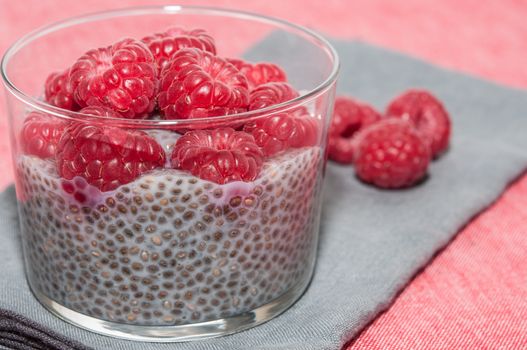 Pudding raspberries and chia seeds on a tablecloth