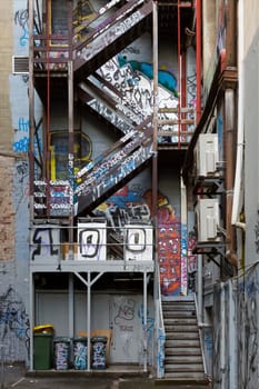 Exterior fire escape stairs covered in Melbourne famous graffiti in Hosier Lane.