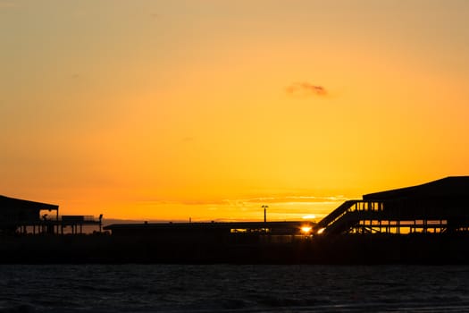 Silhouette of Station Pier in Melbourne with the sunsetting in the background.