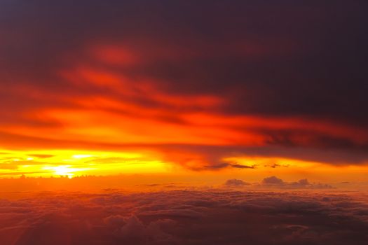 Sunset with clouds over view from airplane flying