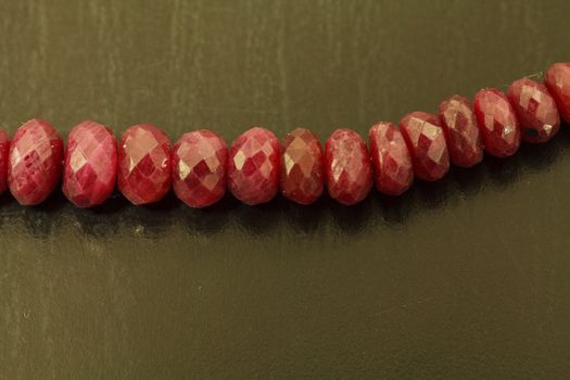 Necklace string of natural ruby bead jewelry on a black background