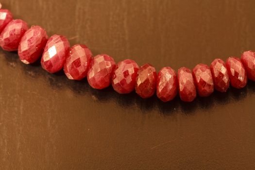 Necklace string of natural ruby bead jewelry on a black background