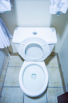Clean Toilet Bowl in a Small Bathroom Vertical Photo. Home Interior.