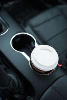 Coffee Drinking While Driving. Single Paper Coffee Cup Inside Car Cup Holder. 
