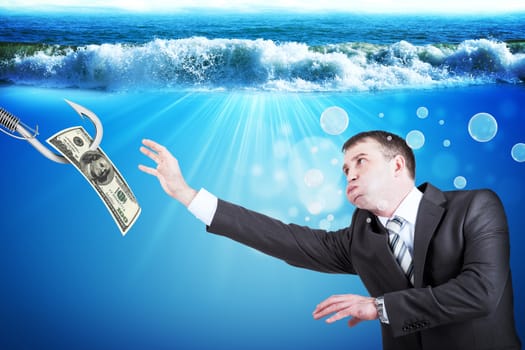 Businessman with inflated cheeks under water with hook and dollars