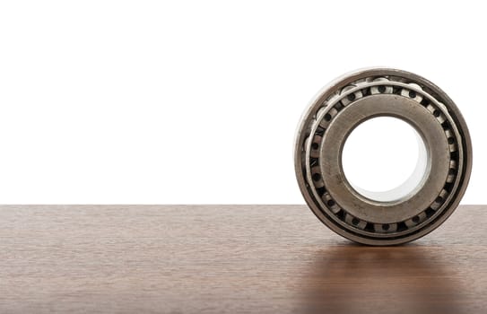 Roller bearing on table isolated on white background, close up