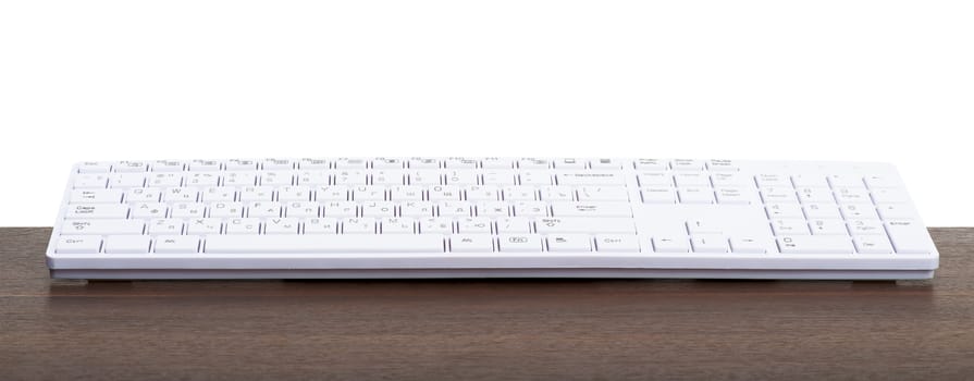 Computer keyboard on table isolated on white background