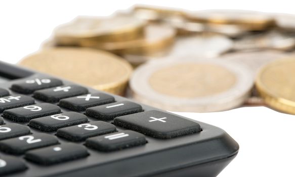 Calculator with coins isolated on white background