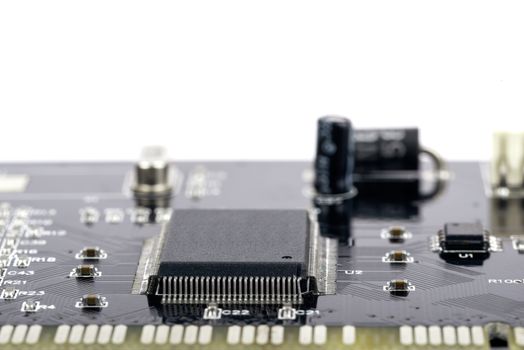 Electronic circuit board with processor on white, close up
