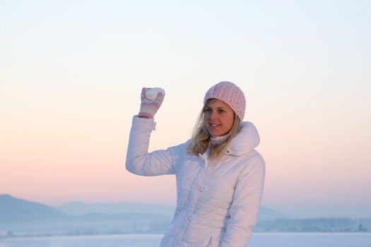 Nice girl at winter sunset