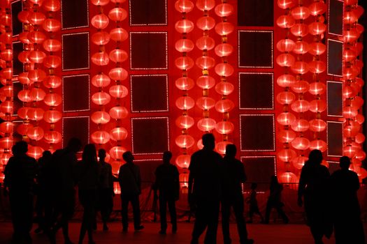 MALAYSIA, Kuala Lumpur: People walk past red lantern decorations ahead of Lunar New Year celebrations at a shopping mall in front of Petronas Twin Towers in Kuala Lumpur on January 25, 2016.