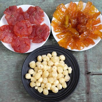 Amazing of Vietnamese food for Tet holiday in spring, jam is traditional food on lunar new year, make from sweet potato, lotus seed, ginger, mango with sugar, colorful background for Vietnam culture