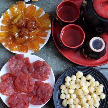Amazing of Vietnamese food for Tet holiday in spring, jam is traditional food on lunar new year, make from sweet potato, lotus seed, ginger, mango with sugar, colorful background for Vietnam culture