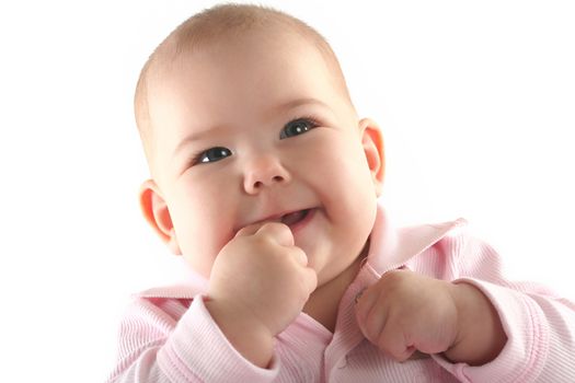 Cute baby girl smiling with thumb in her mouth