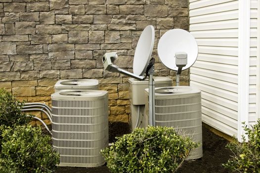 Air conditioner units and satellite dishes at apartment complex