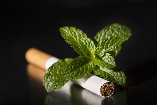cigarette with fresh mint, on black background