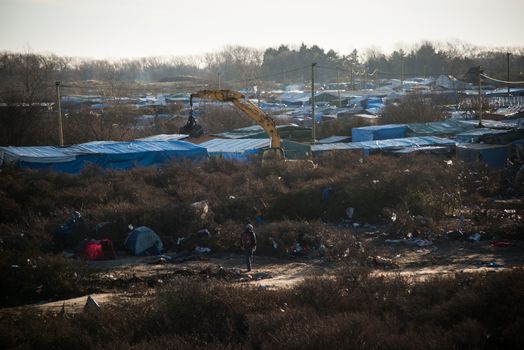 FRANCE, Calais: A bulldozer demolishes part of the Jungle in Calais, northern France on January 25, 2016.